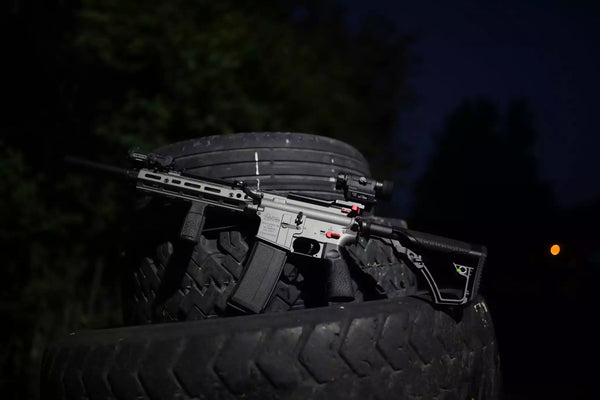 Rifle mounted on a tire with a dark background